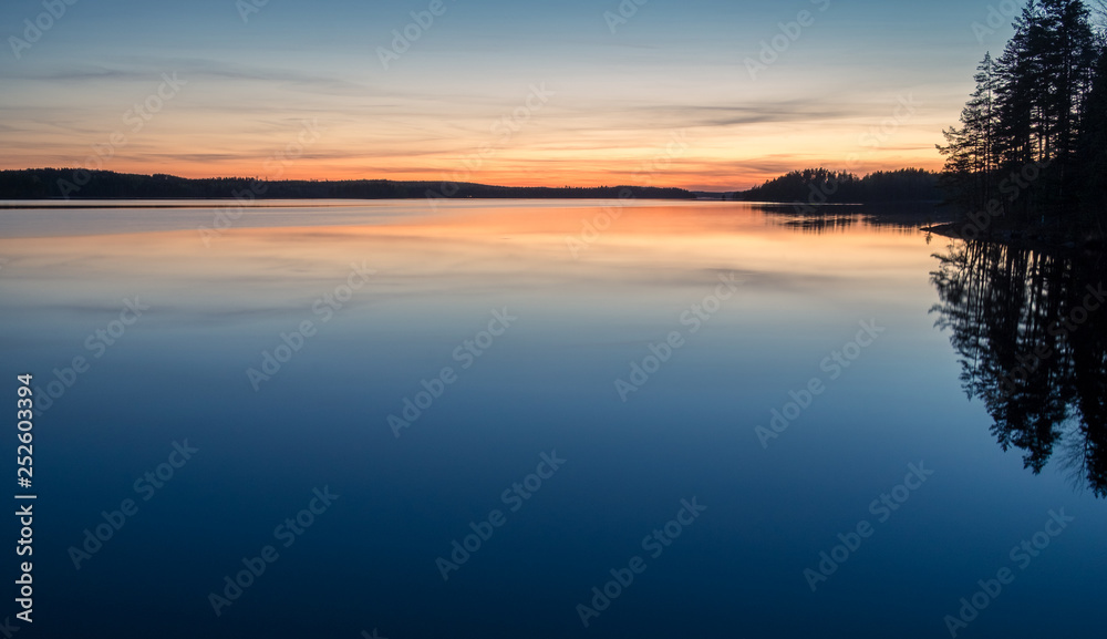 Obraz premium Scenic dawn landscape with lake after sunset at spring evening in Finland