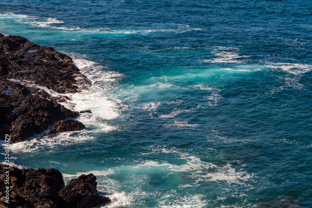 beautiful view on ocean water and black lava sand beautiful view on ocean water and black lava sand