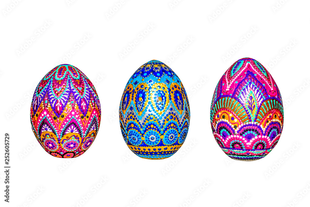 Wooden Easter eggs, painted in patterns by hand with acrylic paints, isolated on a white background.