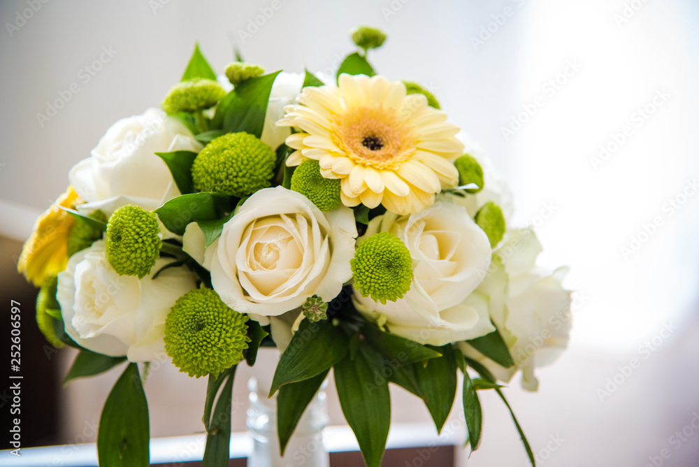 Wedding bouquet made of fresh flowers - white roses and yellow gerbera. 