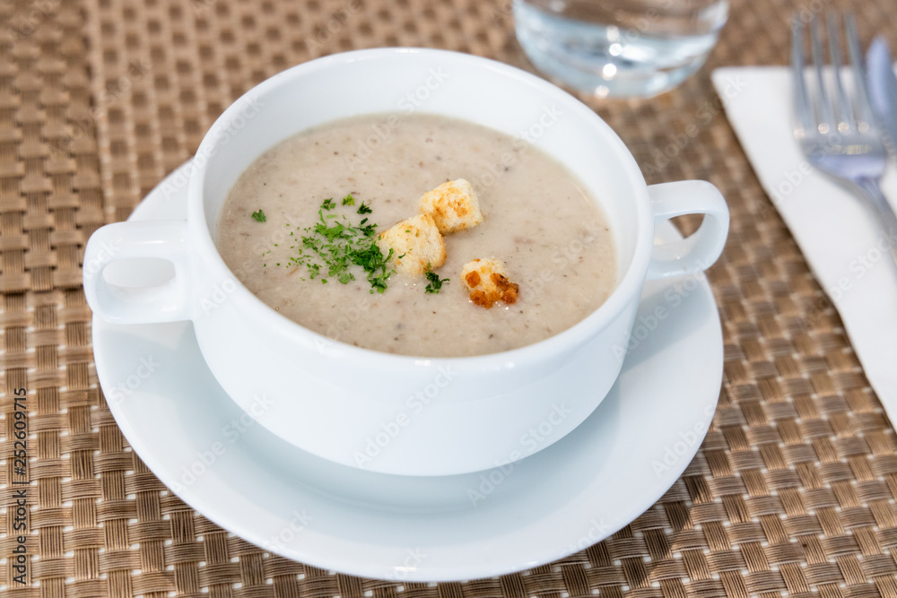 Serving of cream wild mushroom soup at restaurant Serving of cream wild mushroom soup at restaurant