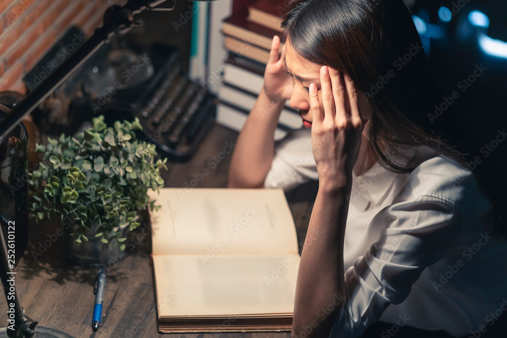 tired asian office woman work hard sleepless all night work with ton of book and documents on table tired asian office woman work hard sleepless all night work with ton of book and documents on table