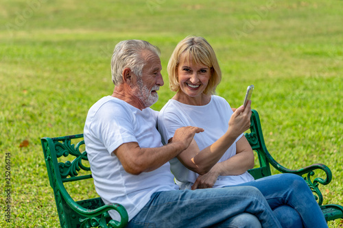 elderly man and woman video call with smartphone in public park © jiradet_ponari