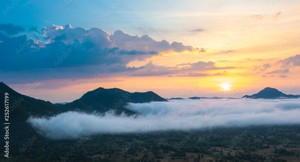 Beautiful dramatic sunset in the mountains. Landscape lot of fog Phu Thok Mountain at Chiang Khan ,Loei Province in Thailand.