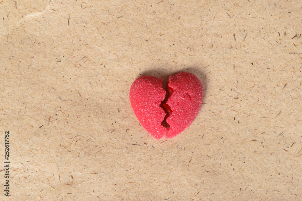 Fototapeta premium Broken candy heart on paper