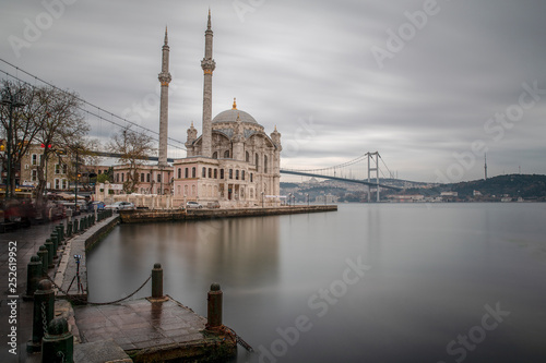 Ortakoy Mosque - Day to night time lapse scene of the beautiful renovated Ortakoy mosque in Istanbul with Bosphorus bridge in the background. Turkey