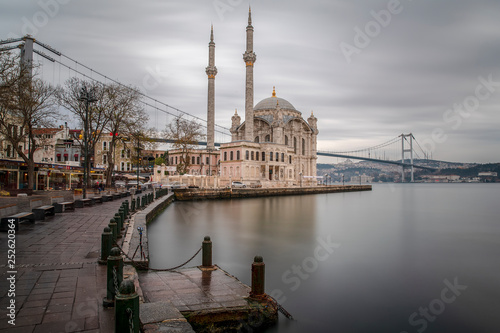 Ortakoy Mosque - Day to night time lapse scene of the beautiful renovated Ortakoy mosque in Istanbul with Bosphorus bridge in the background. Turkey