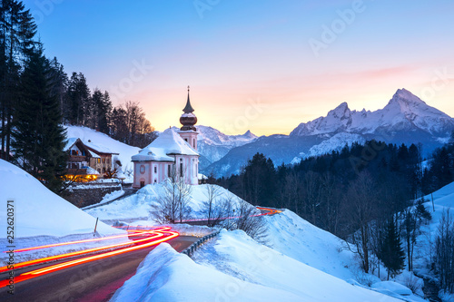 Beautiful winter wonderland mountain scenery in the Alps with pilgrimage church of Maria Gern and famous Watzmann summit in the background, Berchtesgadener Land, Bavaria, Germany © Aleh Varanishcha
