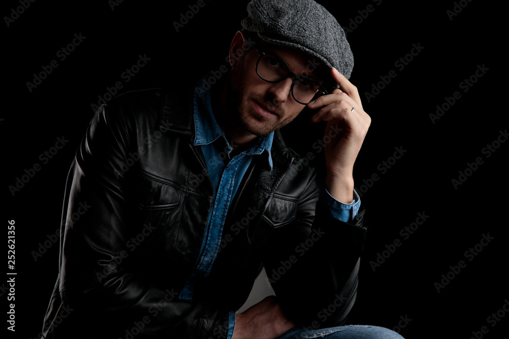 man with eyeglasses holding his hand at cap man with eyeglasses holding his hand at cap