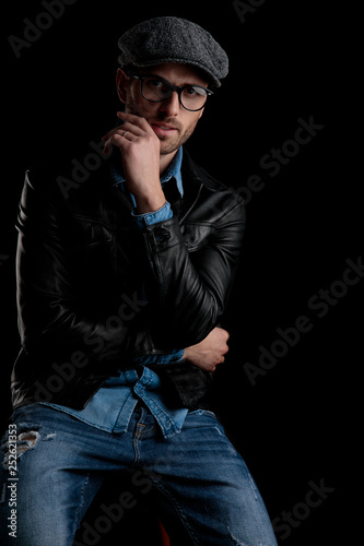 man with eyeglasses holding his hand at chin