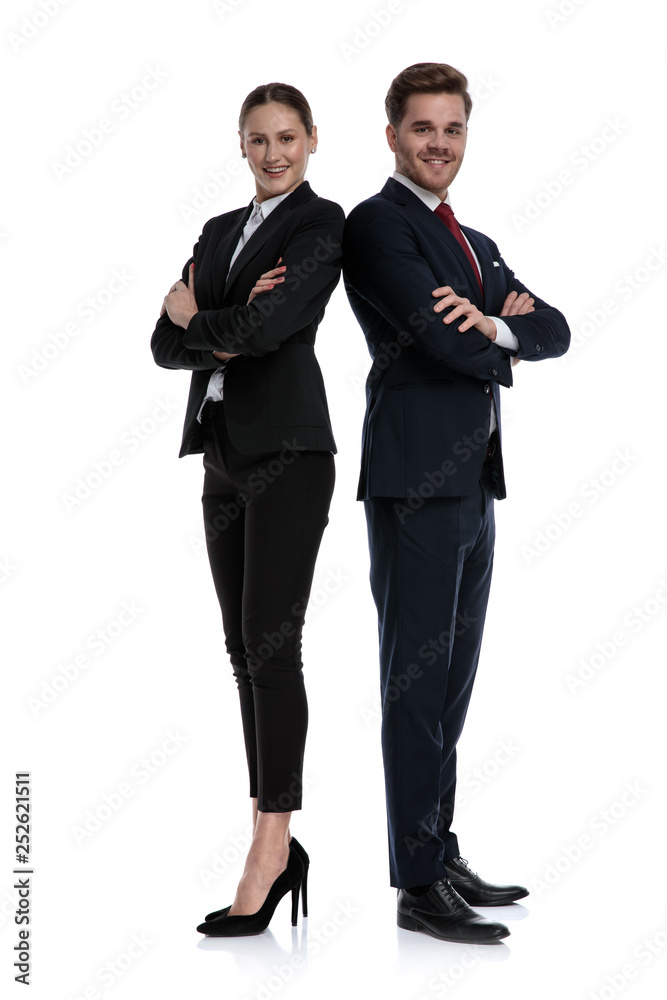 couple in business suits standing back to back couple in business suits standing back to back