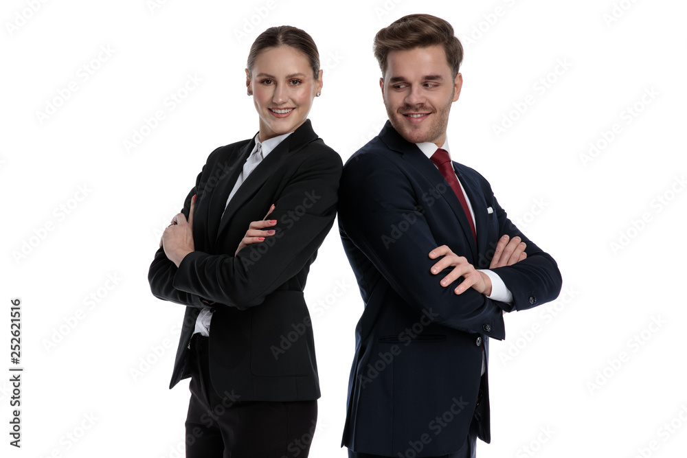 couple in business suits standing back to back couple in business suits standing back to back
