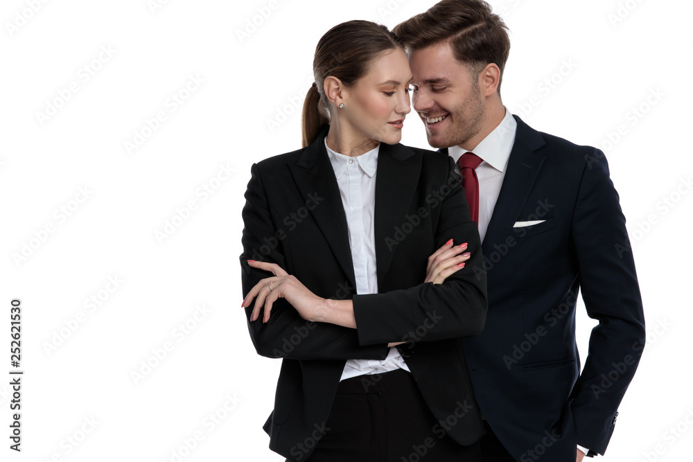 couple in business suits standing together smiling couple in business suits standing together smiling