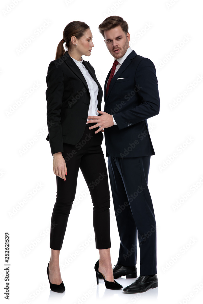 couple in business suits holding hand on waist couple in business suits holding hand on waist