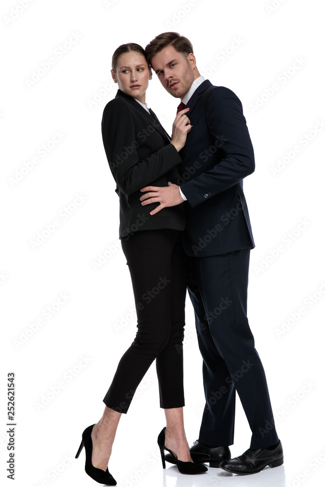 couple in business suits holding hands on each other couple in business suits holding hands on each other