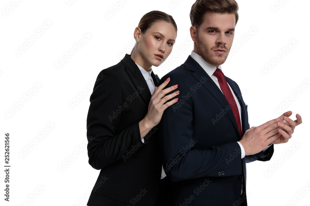 couple in business suits holding hands together couple in business suits holding hands together