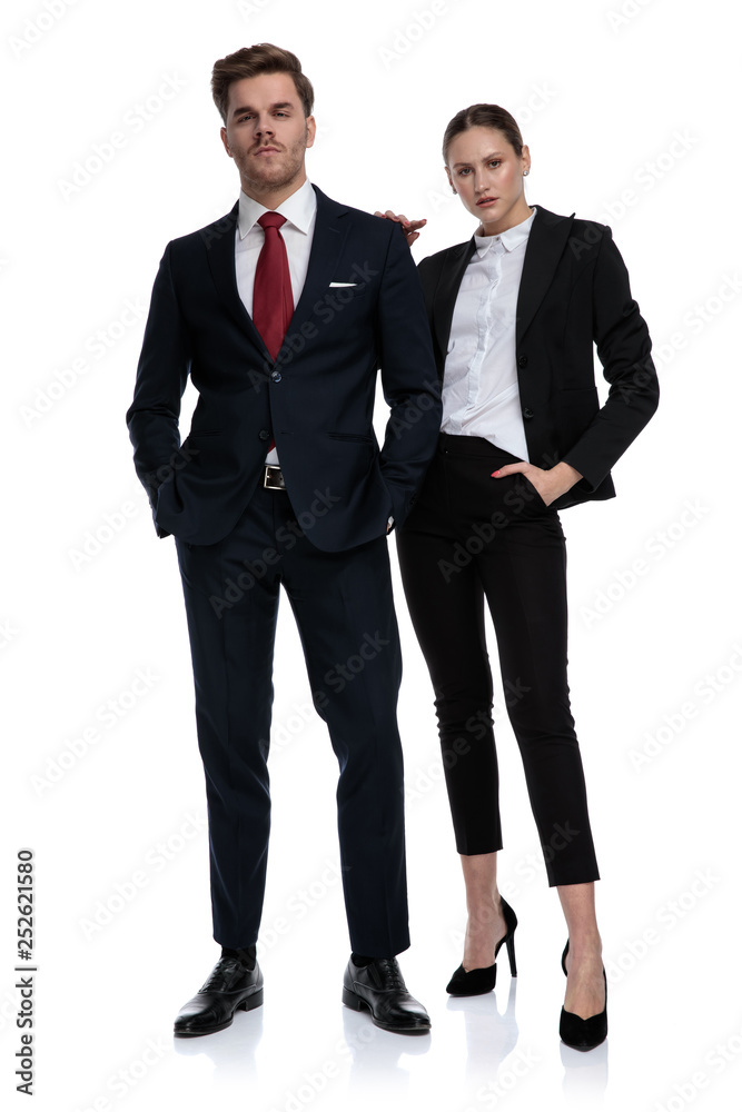 couple in business suits looking serious couple in business suits looking serious