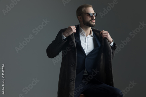 guy adjusting his collar with both hands