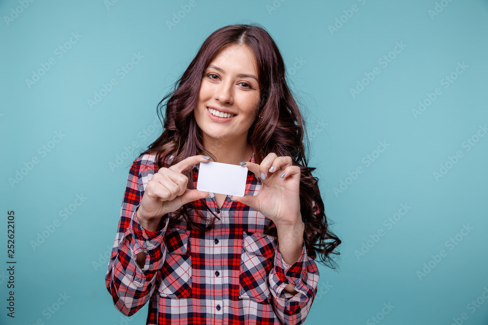 Handsome smiling young woman showing white credit card Handsome smiling young woman showing white credit card