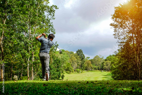 Golfer playing golf in beautiful golf course in the evening golf course with sunshine in thailand