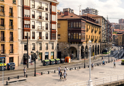 Bilbao, Spain-September, 2018. Street of a city with people walking in them in a sunny day. Describe the ciry life © Tomas