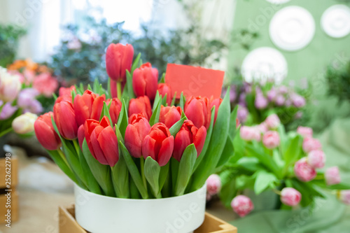 Chic bouquet of red tulips with a sign copyspace, Hello Spring and Woman day concepts