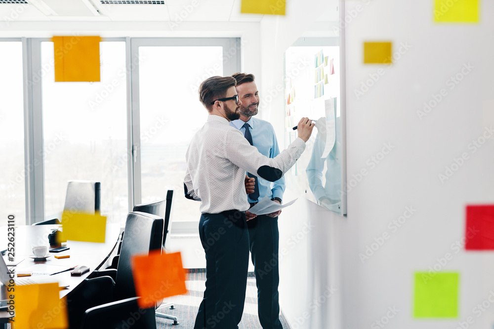 Two business people working together in modern office Two business people working together in modern office