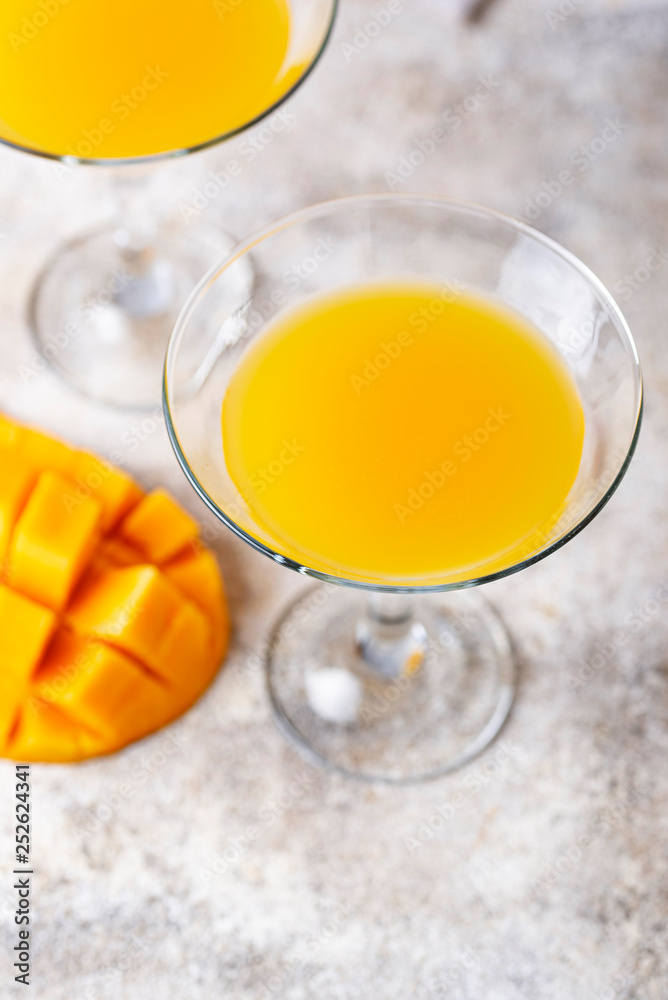 Tropical cocktail with mango on light background Tropical cocktail with mango on light background