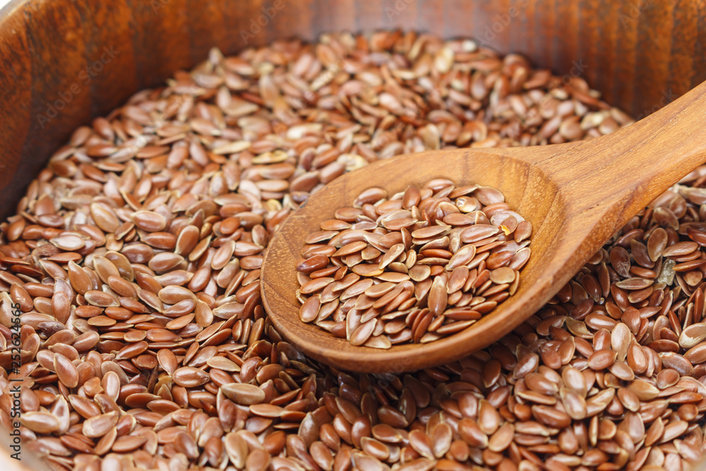 Brown flax seed in bowl and spoon. Brown flax seed in bowl and spoon.