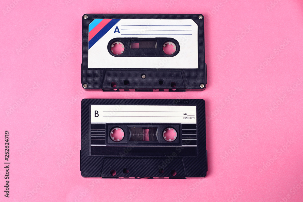 Fototapeta premium group of two audio retro vintage cassette tape 80s style on pink background
