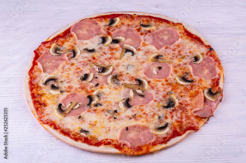 Pizza with a carbonate and champignons with tomato sauce