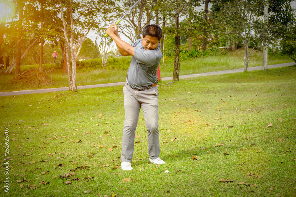 Golfer playing golf in beautiful golf course in the evening golf course with sunshine in thailand