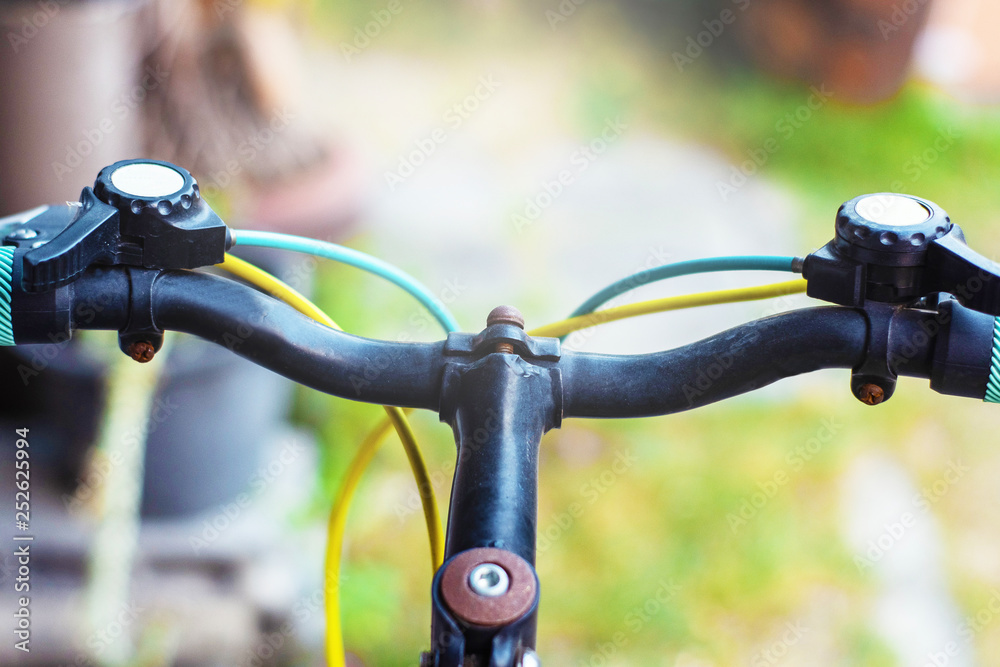 Closeup hand brake mountain bike handle caliper bicycle blurred tree background for Exercise for health image Closeup hand brake mountain bike handle caliper bicycle blurred tree background for Exercise for health image