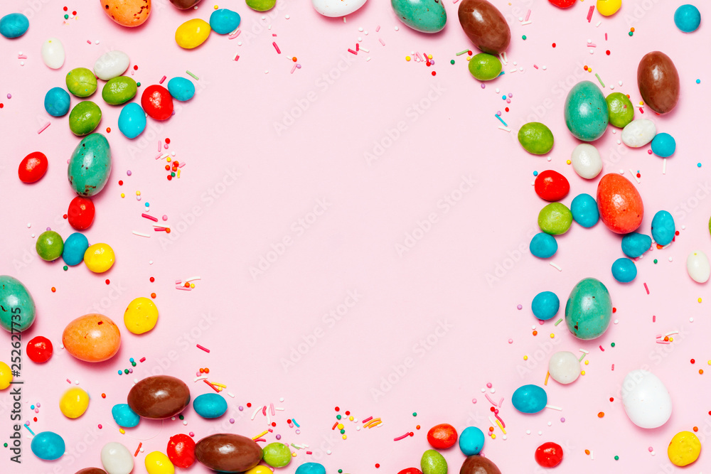 Easter frame made from colorful eggs and big chocolate egg flat lay on white background. Top view, copyspace for text. Easter frame made from colorful eggs and big chocolate egg flat lay on white background. Top view, copyspace for text.