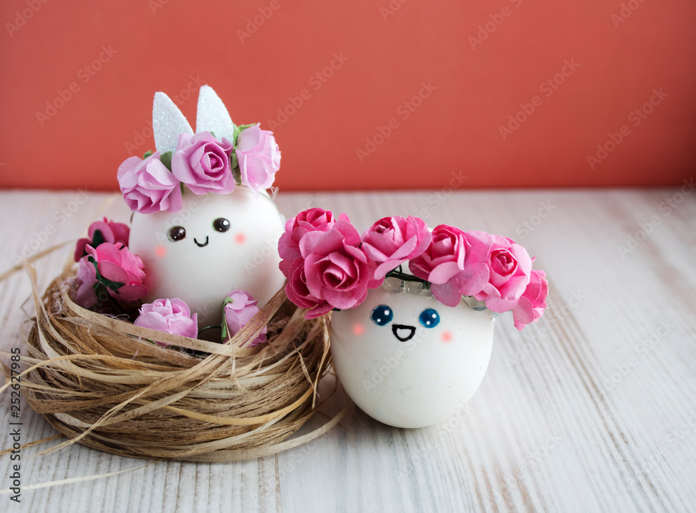 Easter holiday concept with cute handmade eggs, set of kawaii cute eggs with wreaths of pink flowers in the nest.Easter outfit Easter holiday concept with cute handmade eggs, set of kawaii cute eggs with wreaths of pink flowers in the nest.Easter outfit