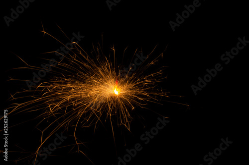 Bengal fire. New year sparkler candle on black background