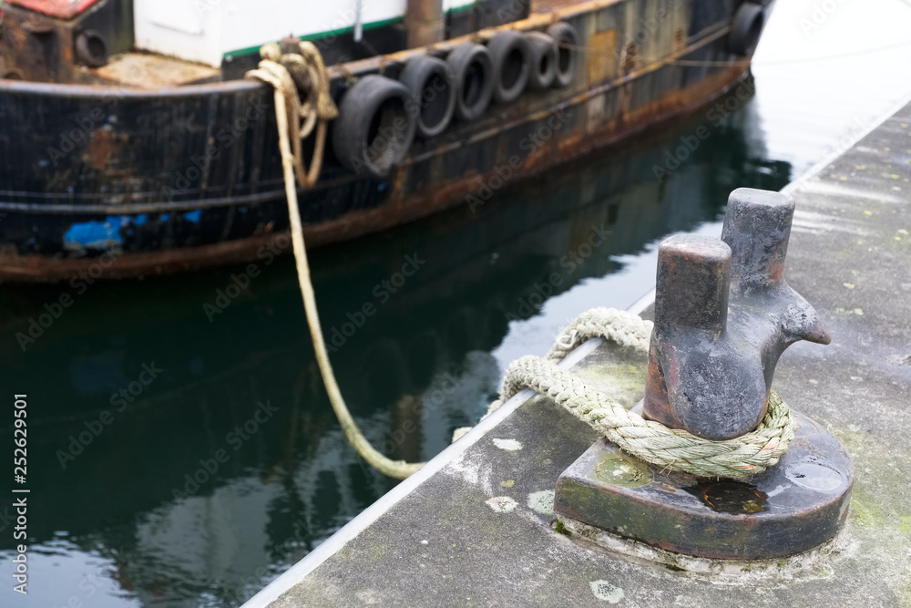 Tyres rubber on wooden boat at port harbour