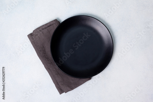 black plate and linen napkin