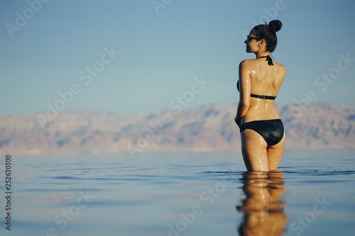 brunette girl swimming in the dead sea in israel