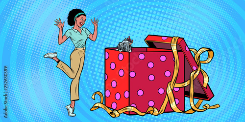 dog puppy holiday gift box. African woman funny reaction joy