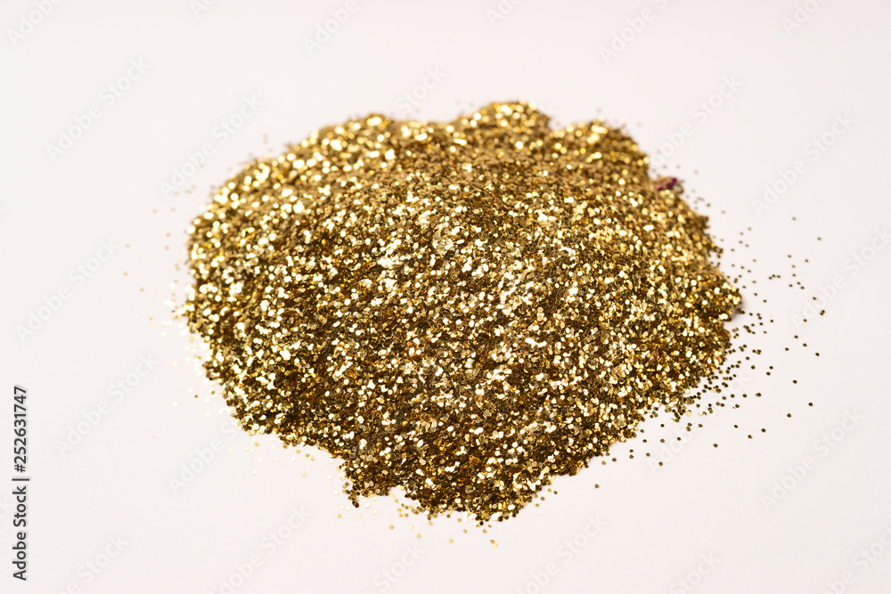 A bunch of golden nail gritter for manicure. Golden glitter shining on daylight. Stock photo isolated on white background. Varnish topping. A bunch of golden nail gritter for manicure. Golden glitter shining on daylight. Stock photo isolated on white background. Varnish topping.