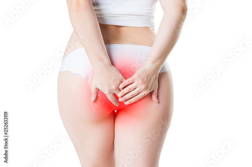 Woman suffering from hemorrhoids, anal pain isolated on white background