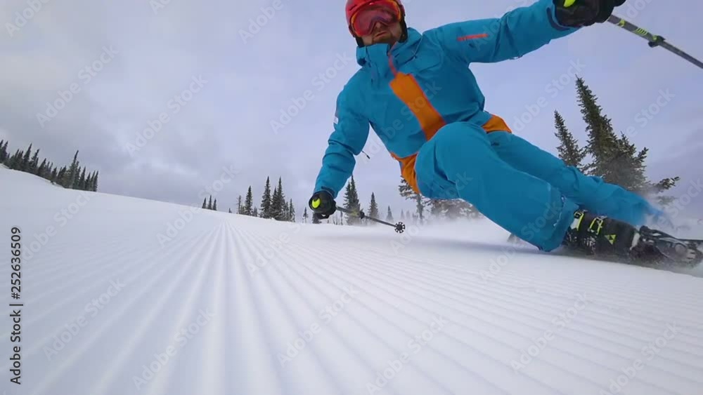 skier makes a turn on the ski track. lie down in turn touching the snow. at the fresh velvet from snowgroomers. ski carving. super slow video. the edges of the snow from the groomer. video footage