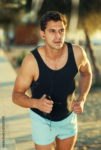 Man running along embankment