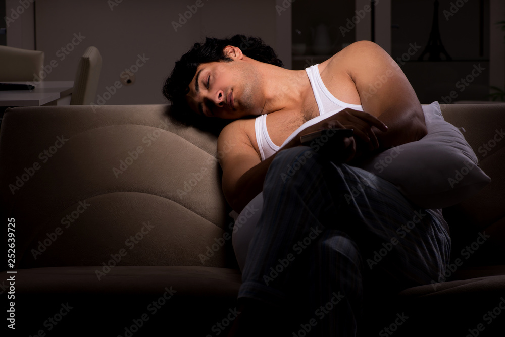 Young man suffering at home night time Young man suffering at home night time