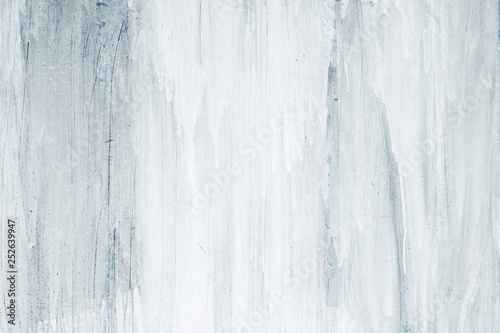 White and blue paint dripping on a surface, abstract background or texture
