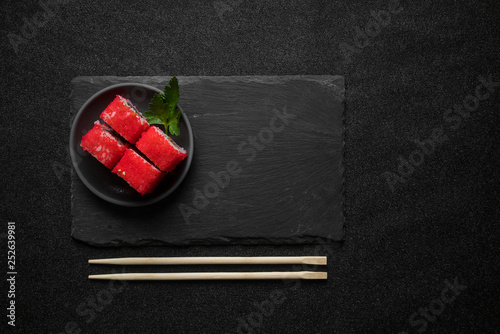 Foto Sushi rolls, maki, nigiri on black stone slate on dark background copy space