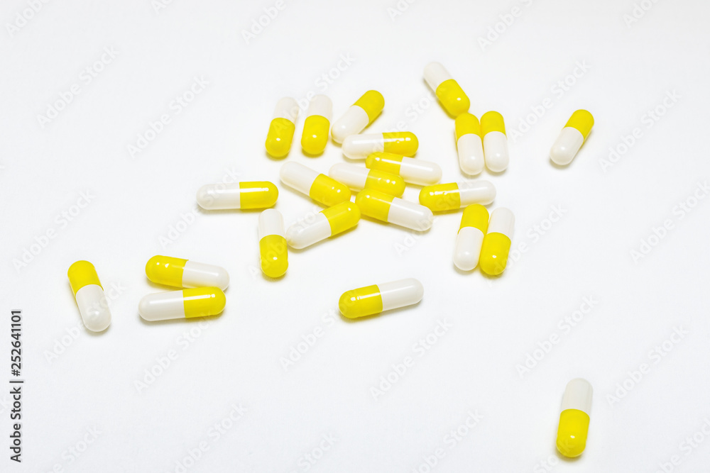 Pile of scattered capsules on a white background. Pile of scattered capsules on a white background.