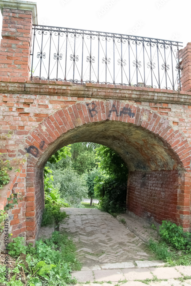 old brick bridge with iron fence