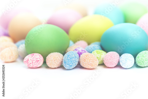 Colorful Assorted sizes Pastel Happy Easter Eggs sunny background with copy space